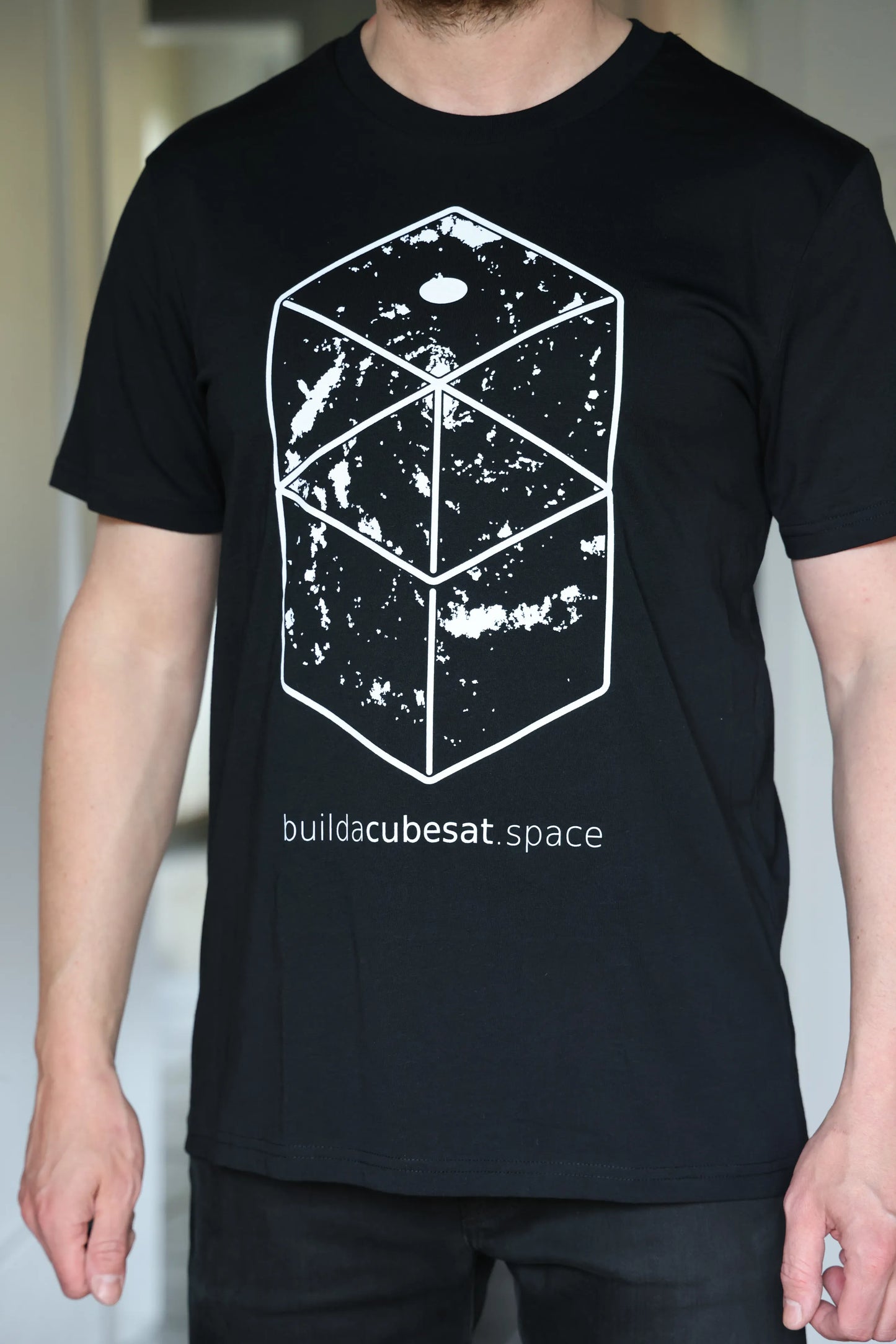 Black t-shirt with a white geometric space design and text on a plain background